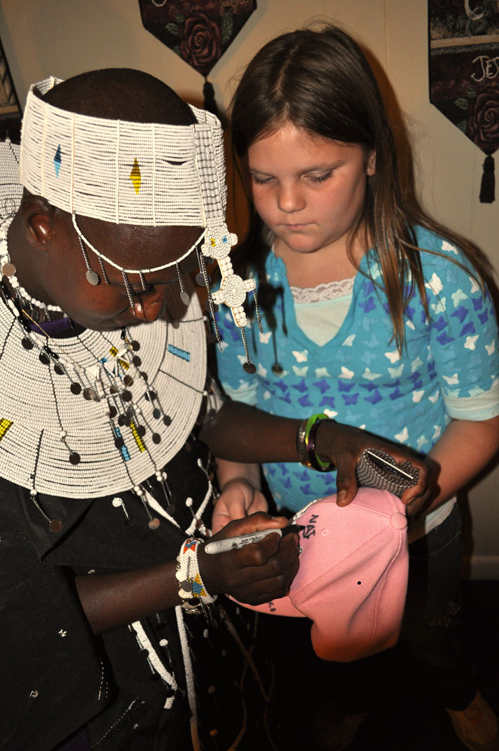 Natapoaki signing Jewel's hat